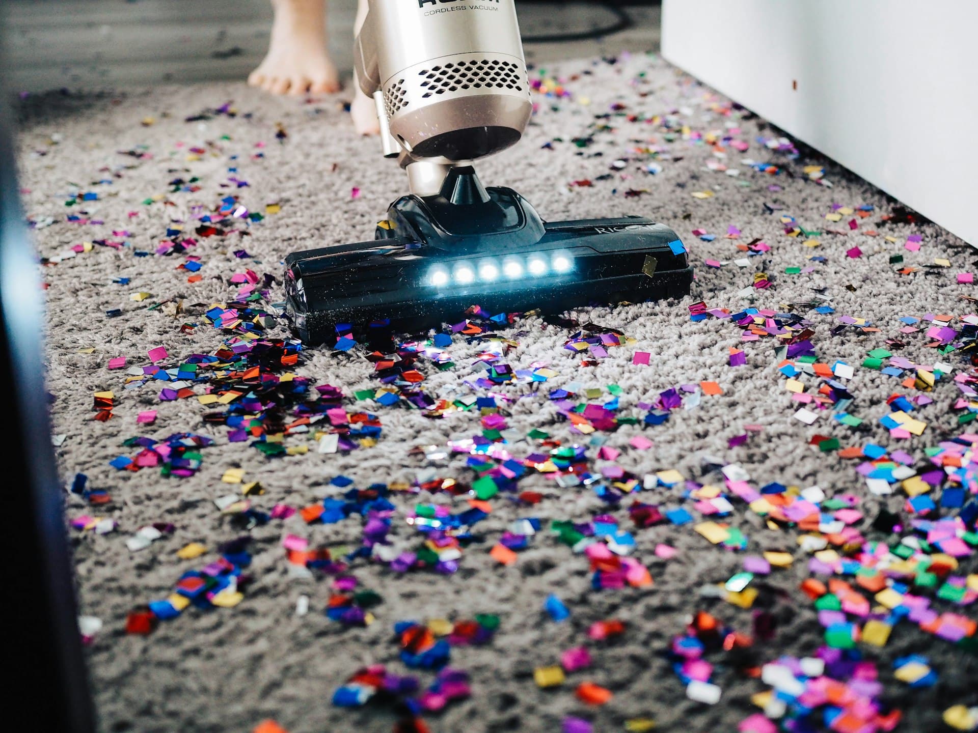 A vacuum cleaning a carpet